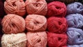 Multi-colored yarn on the showcase. Yarn for warm clothes. Yarn in skeins of red, peach and purple. Knit clothes