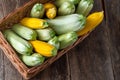 Multi-colored zucchini yellow, green, white, orange on the wooden table close-up. Food background. Fresh harvested Royalty Free Stock Photo