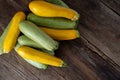 Multi-colored zucchini yellow, green, white, orange on the wooden table close-up. Food background. Fresh harvested Royalty Free Stock Photo