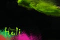 Multi - Colorful dust explode at black background. Celebrate Indian Holi festival of colours