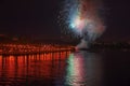 Multi-colors colorful fireworks over the city at night with water reflection. Celebration. Abstract holiday background Royalty Free Stock Photo