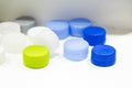 The multi-colors plastic bottle caps on the white background. Royalty Free Stock Photo