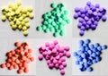 Multi colour of drug pills in orange ,magenta,yellow,navy blue,purple,pink on white background Royalty Free Stock Photo