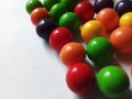 Multi coloured candy gum balls on white background