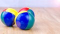 Multi-Coloured juggle balls on wooden surface