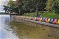 Multi coloured Muskoka Chairs in the lake front of the tourist resort with the patio gazebo Royalty Free Stock Photo