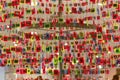 Multi coloured, patterned hanging keyrings display in a store in Florence, Italy.