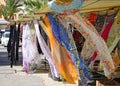 Multi coloured patterned silk scarves blowing in the breeze on a market stall in Marsaxlokk in Malta