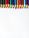 Multi coloured pencil crayons as a border on white