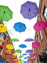 Multi coloured umbrellas floating in the sky