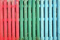 Multi coloured wooden stake fence