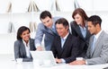 Multi-cultural business team looking at a laptop Royalty Free Stock Photo