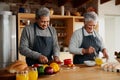 Happy multi-cultural elderly couple preparing meal in modern kitchen. Healthy retired lifestyle at home.