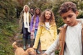 Multi-Cultural Family Walking Down Steps In Countryside With Dog On Winter Beach Vacation Royalty Free Stock Photo