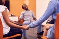 Multi-Cultural Group Of Men And Women Joining Hands At Mental Health Group Therapy Meeting Royalty Free Stock Photo