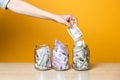 Multi-currency accounts, concept. Dollars and euros in a glass jar on a bright yellow background Royalty Free Stock Photo