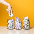 Multi-currency accounts, concept. Dollars and euros in a glass jar on a bright yellow background Royalty Free Stock Photo