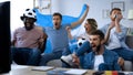 Multi-ethnic Argentinian friends watching game on tv at home, celebrating goal Royalty Free Stock Photo