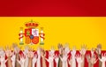 Multi-Ethnic Arms Raised and a Flag of Spain