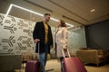 Multi ethnic beautiful couple in love, business partners on business trip, standing at the exit of VIP meeting room in the airport Royalty Free Stock Photo