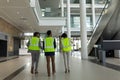 Multi-ethnic business architect discussing over the blue print at office lobby while walking Royalty Free Stock Photo