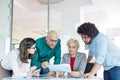 Multi-ethnic business people discussing over document at table in office Royalty Free Stock Photo