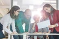 Multi-ethnic business people discussing over document at table in office Royalty Free Stock Photo