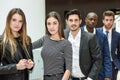 Multi-ethnic business team standing in an office building Royalty Free Stock Photo