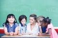 Multi ethnic classroom with teacher explaining mathematics lesson