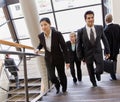 Multi-ethnic co-workerson busy office stairs Royalty Free Stock Photo