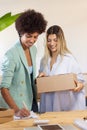 Multi-ethnic colleagues sending parcel to customer Royalty Free Stock Photo