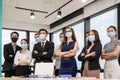 Multi-ethnic confident business team standing with crossed arm and wearing medical mask in modern office Royalty Free Stock Photo