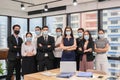 Multi ethnic confident business team standing with crossed arms and wearing medical mask in new normal office Royalty Free Stock Photo