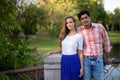 Multi ethnic couple standing together on the bridge of peaceful Royalty Free Stock Photo