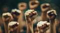 Multi ethnic fists raised up in sign of protest and social unrest, cut out, isolated on black background.