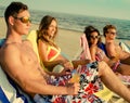 Multi ethnic friends sunbathing on a beach Royalty Free Stock Photo