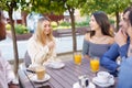 Multi-ethnic group of friends having a drink together in an outdoor bar. Royalty Free Stock Photo