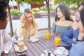 Multi-ethnic group of friends having a drink together in an outdoor bar. Royalty Free Stock Photo