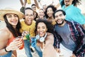 Multi-ethnic group of friends making beach party toasting cocktail glasses together - Guys and girls hanging out