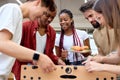 Multi-ethnic group of friends students playing table soccer, at barbecue outdoor party Royalty Free Stock Photo