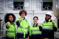 Multi-ethnic group of industrial women men worker team wearing helmet and safety vest, standing giving thumbs up at CNC Royalty Free Stock Photo