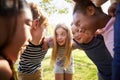 Multi-ethnic group of kids embracing, looking at each other Royalty Free Stock Photo