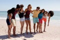Multi-ethnic group of male and female standing on the beach Royalty Free Stock Photo