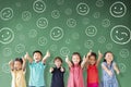 Multi-ethnic group of school children standing in classroom with emotion face