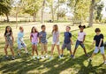 Multi-ethnic group of schoolchildren playing in park Royalty Free Stock Photo