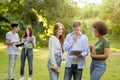 Multi-ethnic group of students spending time together outdoors at college campus Royalty Free Stock Photo