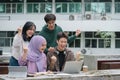 Multi ethnic group of university students raising hands celebration together while looking at laptop screen. Royalty Free Stock Photo