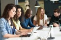 Multi-ethnic group of young people studying with laptop computer Royalty Free Stock Photo