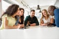 Multi-ethnic group of young people studying together on white de Royalty Free Stock Photo