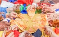 Multi ethnic hands of football friend supporter sharing pizza margherita - Young sport fan toasting beer after game match - Royalty Free Stock Photo